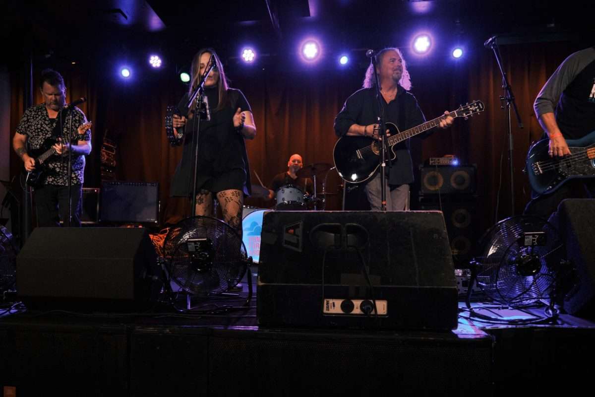 Two guitarists, singer, bass player, and drummer