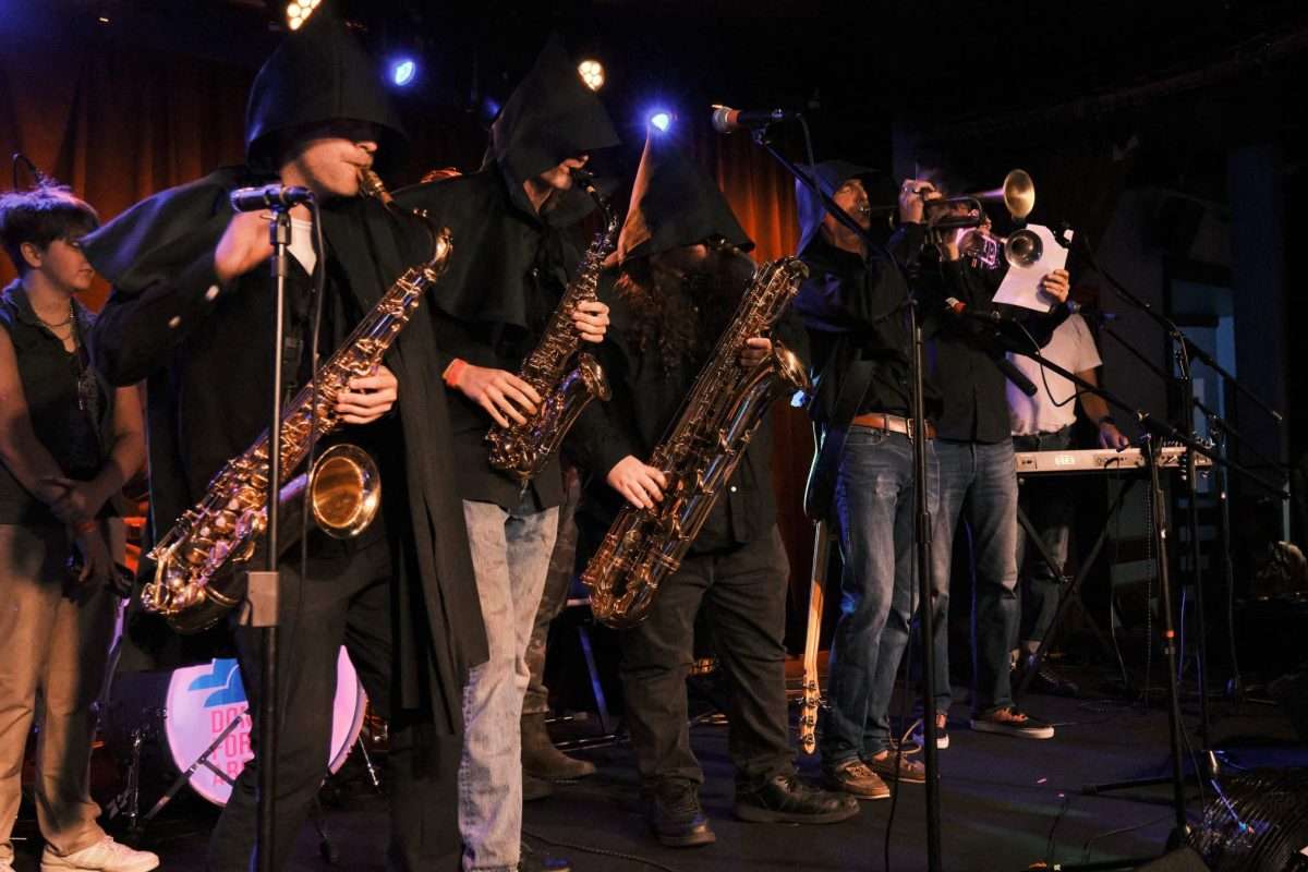 A group of saxophone players on stage